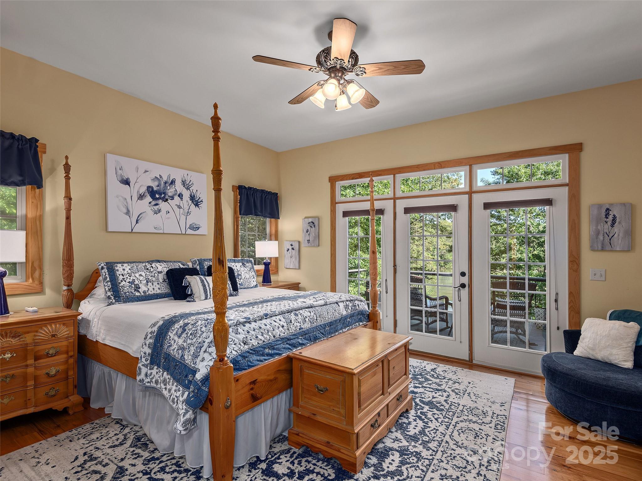 92 Island View Court Mill Spring, NC 28756 - Photo 16 of 48 a bedroom with a large bed a chandelier and a window