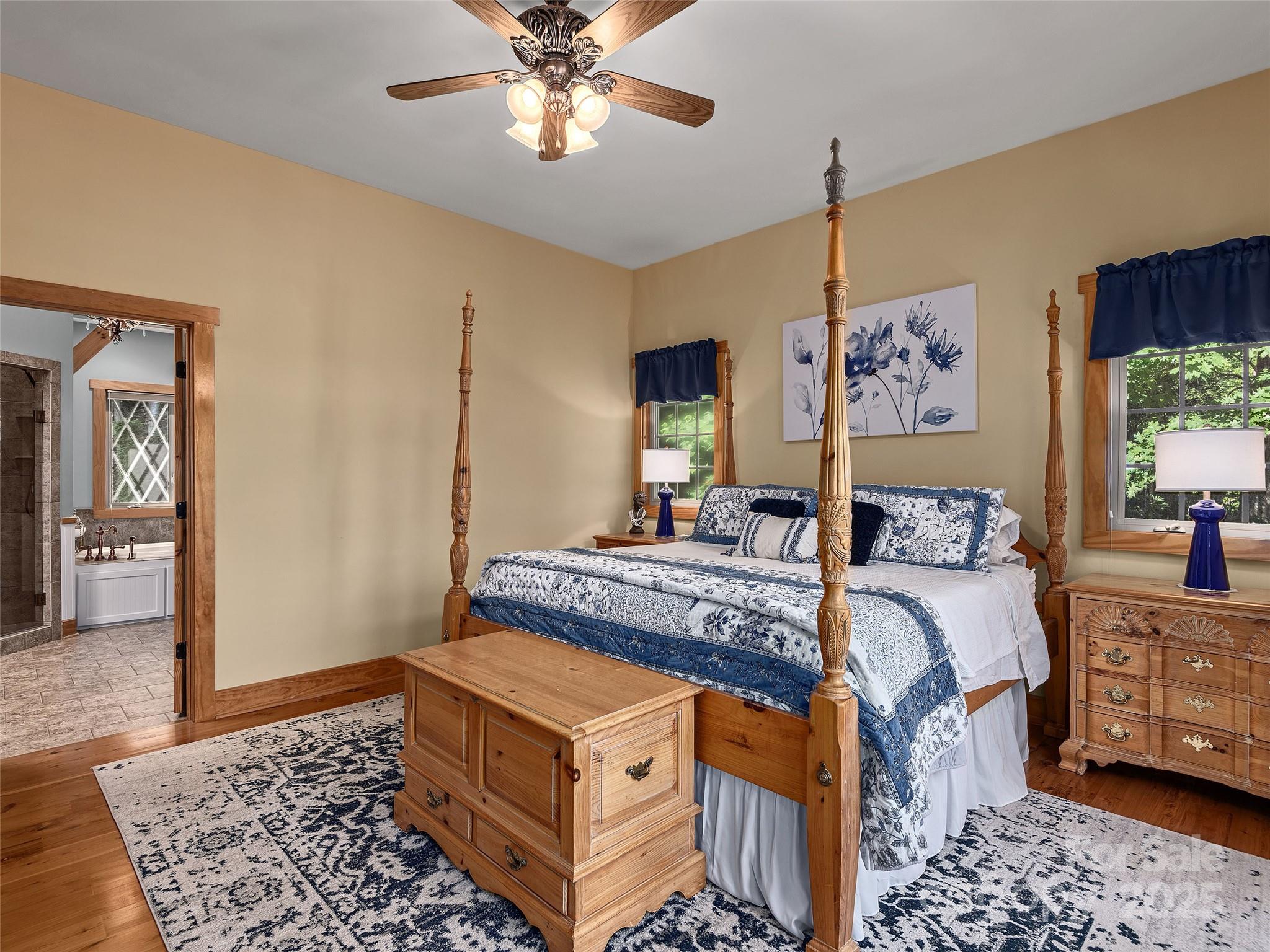 92 Island View Court Mill Spring, NC 28756 - Photo 17 of 48 a bed room with a bed and a chandelier