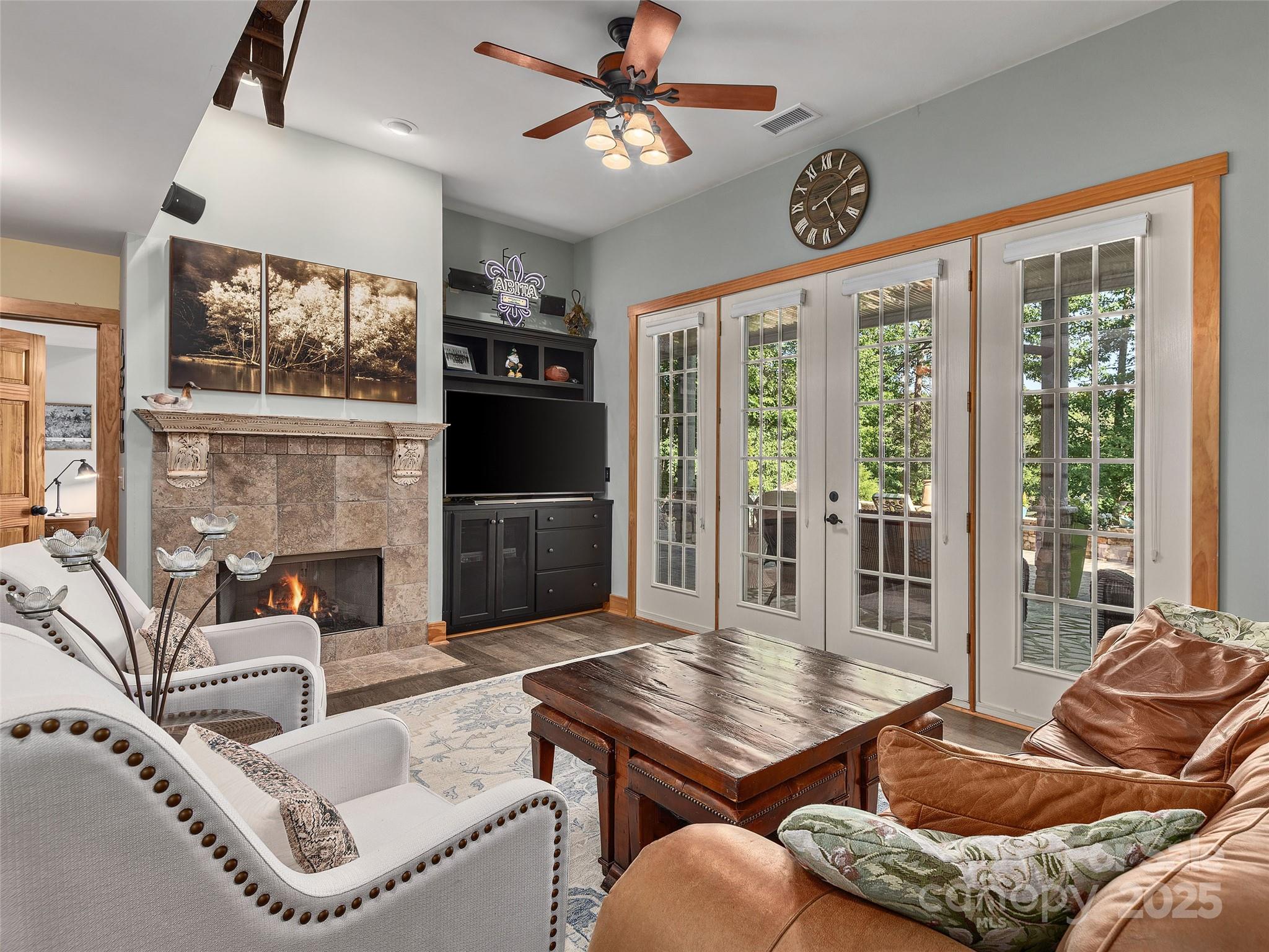 92 Island View Court Mill Spring, NC 28756 - Photo 20 of 48 a living room with furniture a fireplace and a flat screen tv