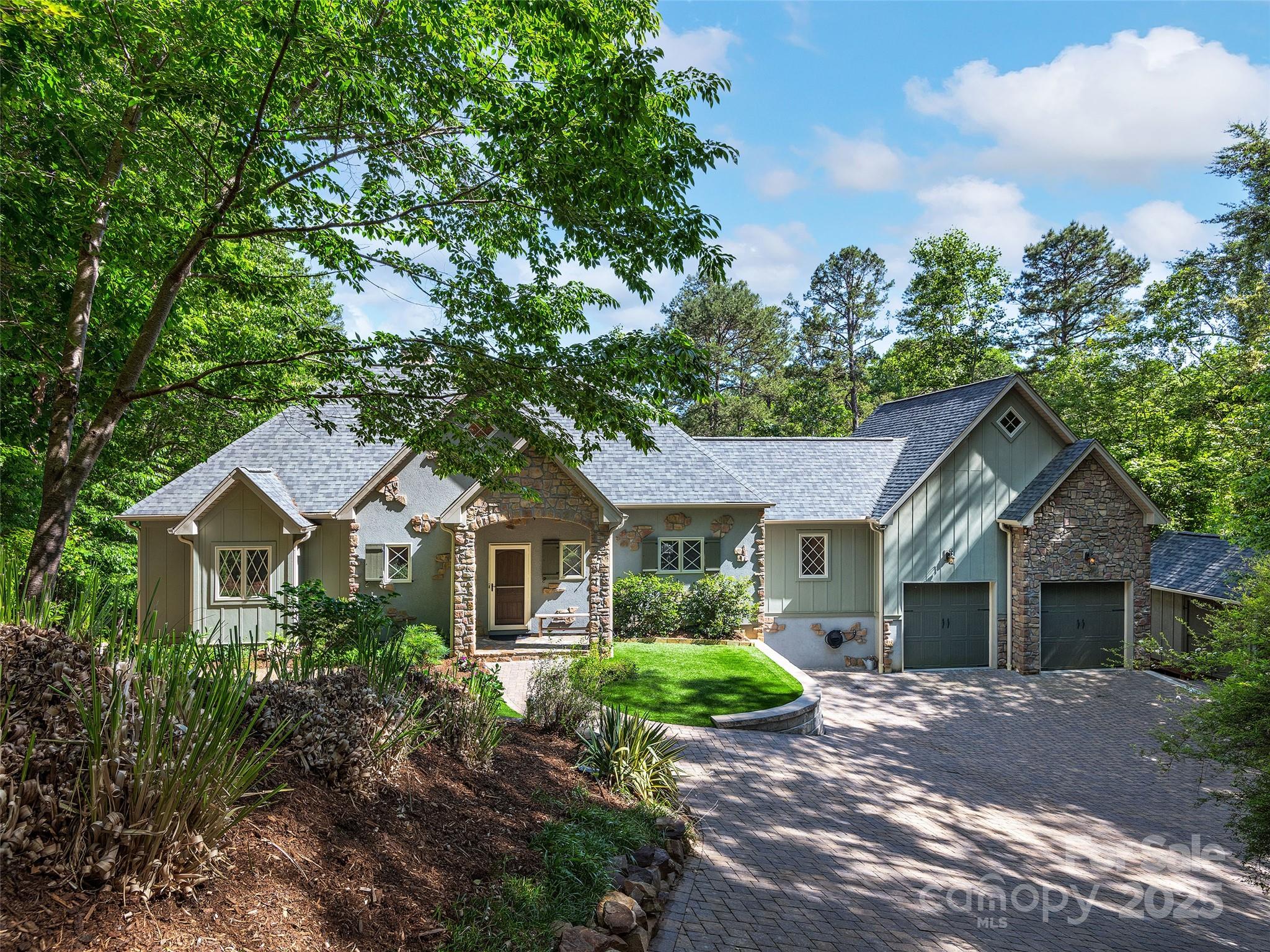 92 Island View Court Mill Spring, NC 28756 - Photo 2 of 48 a front view of a house with a garden