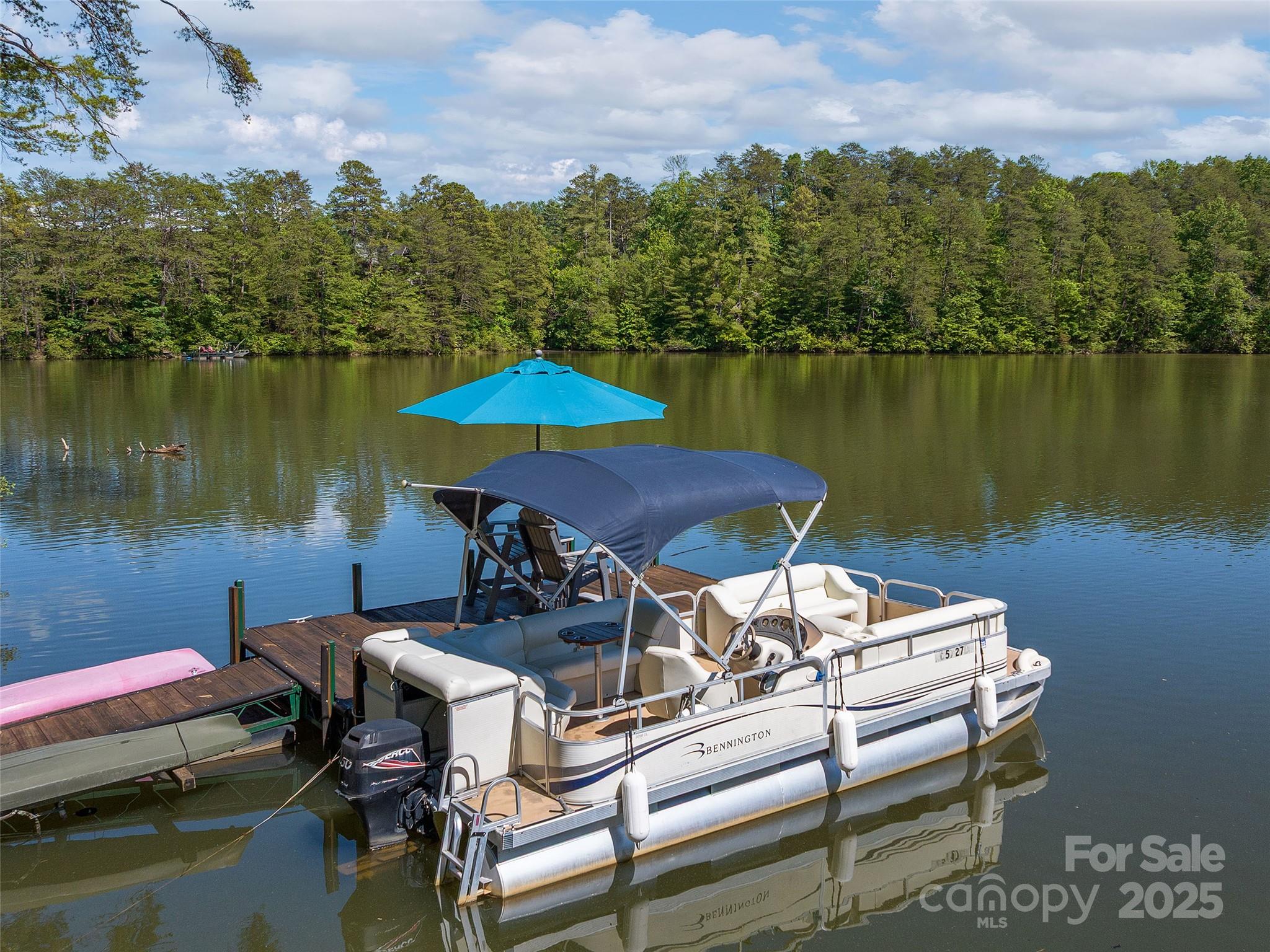 92 Island View Court Mill Spring, NC 28756 - Photo 38 of 48 a view of a lake with a table and chairs