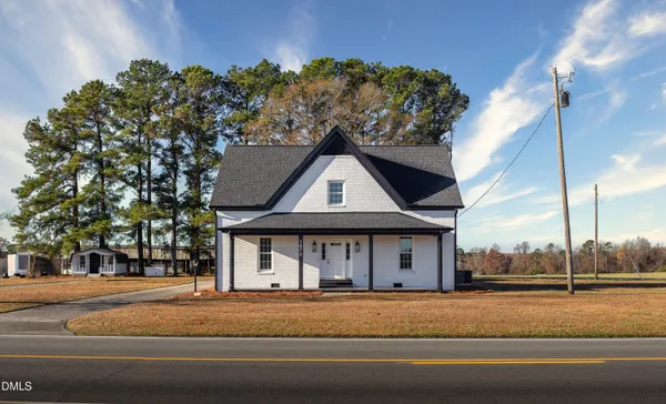 a view of a house with a garden and pathway