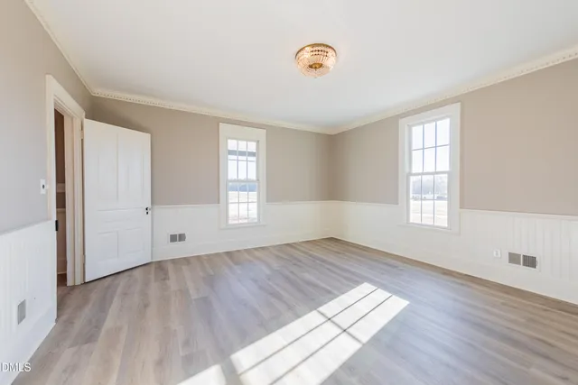 wooden floor in an empty room with a window