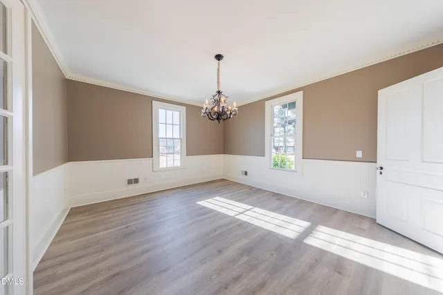 wooden floor in an empty room with a window