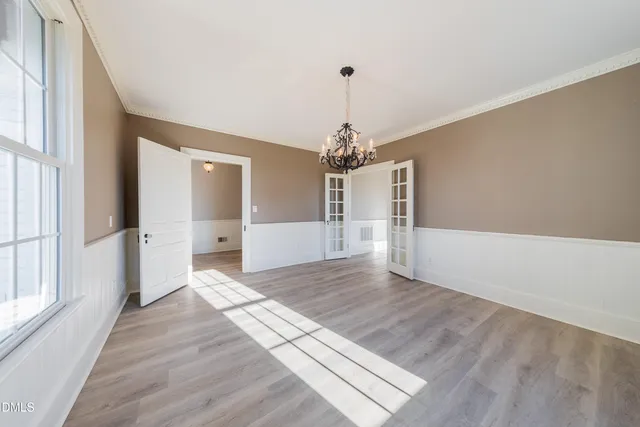 a view of empty room with wooden floor