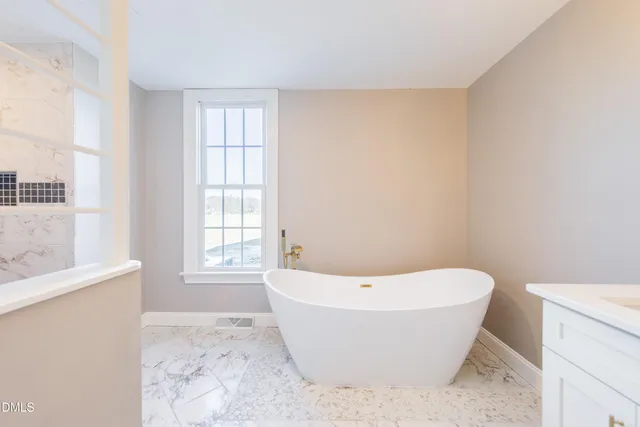 a white bath tub sitting in a bathroom