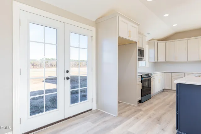 a kitchen with a refrigerator a sink and a stove top oven