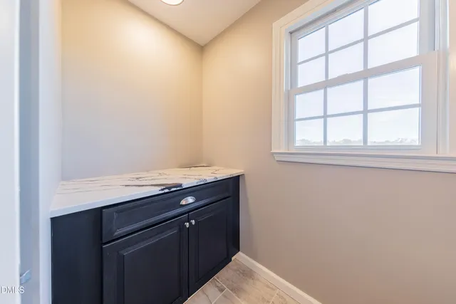 a kitchen with granite countertop white cabinets and white appliances