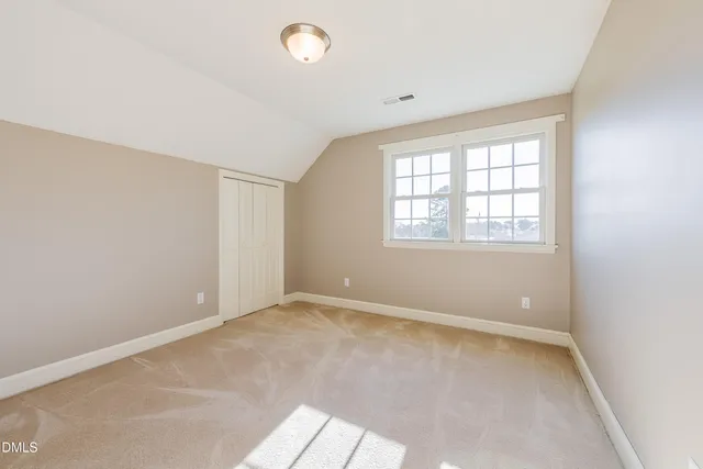 an empty room with windows and closet