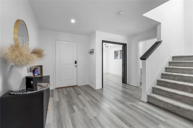 a view of a room with wooden floor and a window