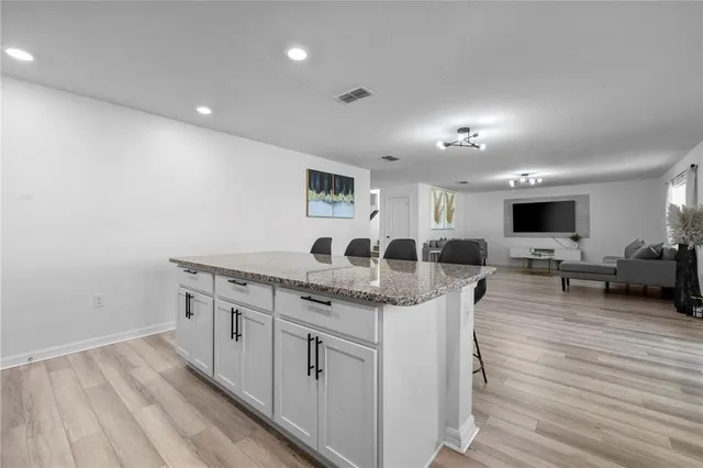 a kitchen with sink cabinets and wooden floor