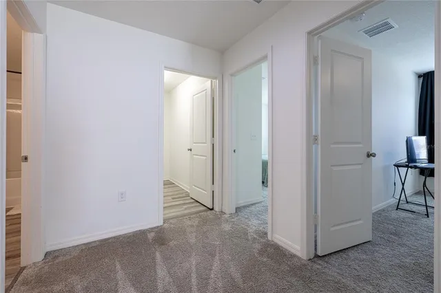 a bedroom with a bed chair and mirror