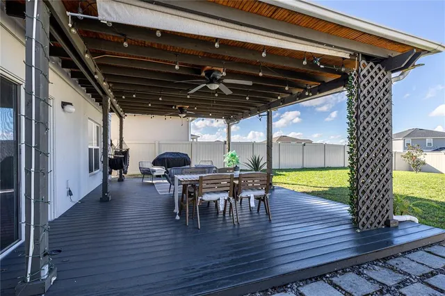 a view of a patio with iron fence