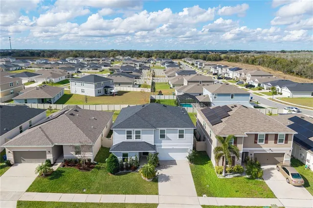an aerial view of residential houses with outdoor space