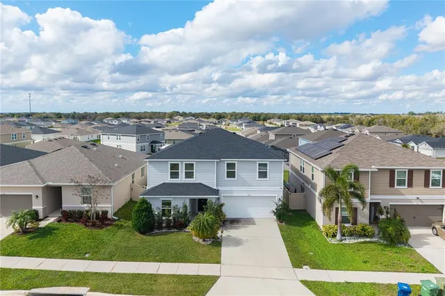 an aerial view of residential houses with outdoor space
