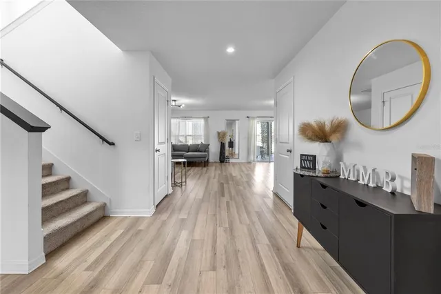 a view of a living room and entryway with wooden floor