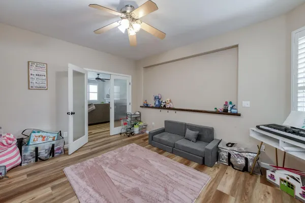 a bathroom with a granite countertop sink a toilet and a mirror