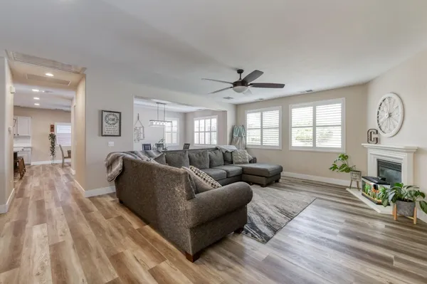a living room with furniture a fireplace and a large window