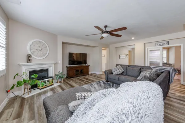 a kitchen with stainless steel appliances granite countertop a sink a stove and a wooden cabinets