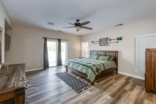 a spacious bathroom with a double vanity sink a large mirror and shower