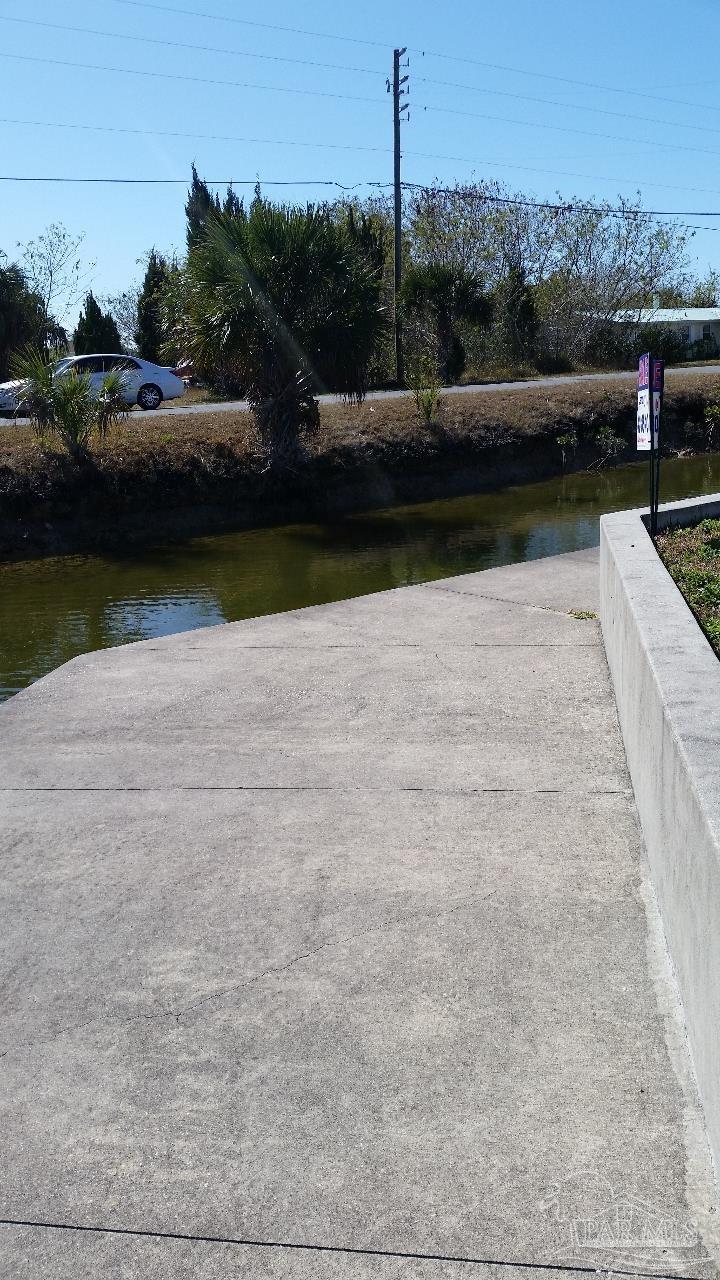 4266 Bellaire Drive Hernando Beach, FL 34607 - Photo 6 of 11 a view of a lake with a car parked