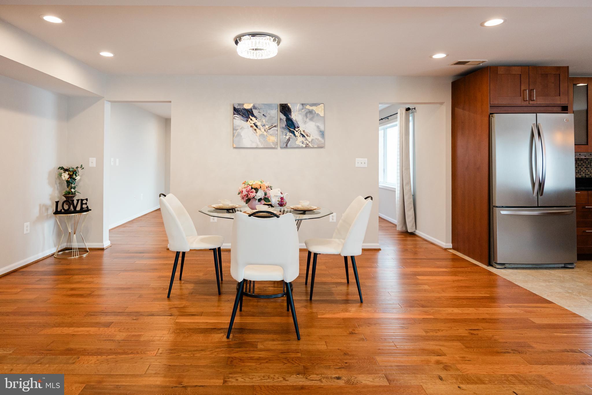9720 Five Oaks Road Fairfax, VA 22031 - Photo 27 of 91 a dining room with furniture a chandelier and wooden floor