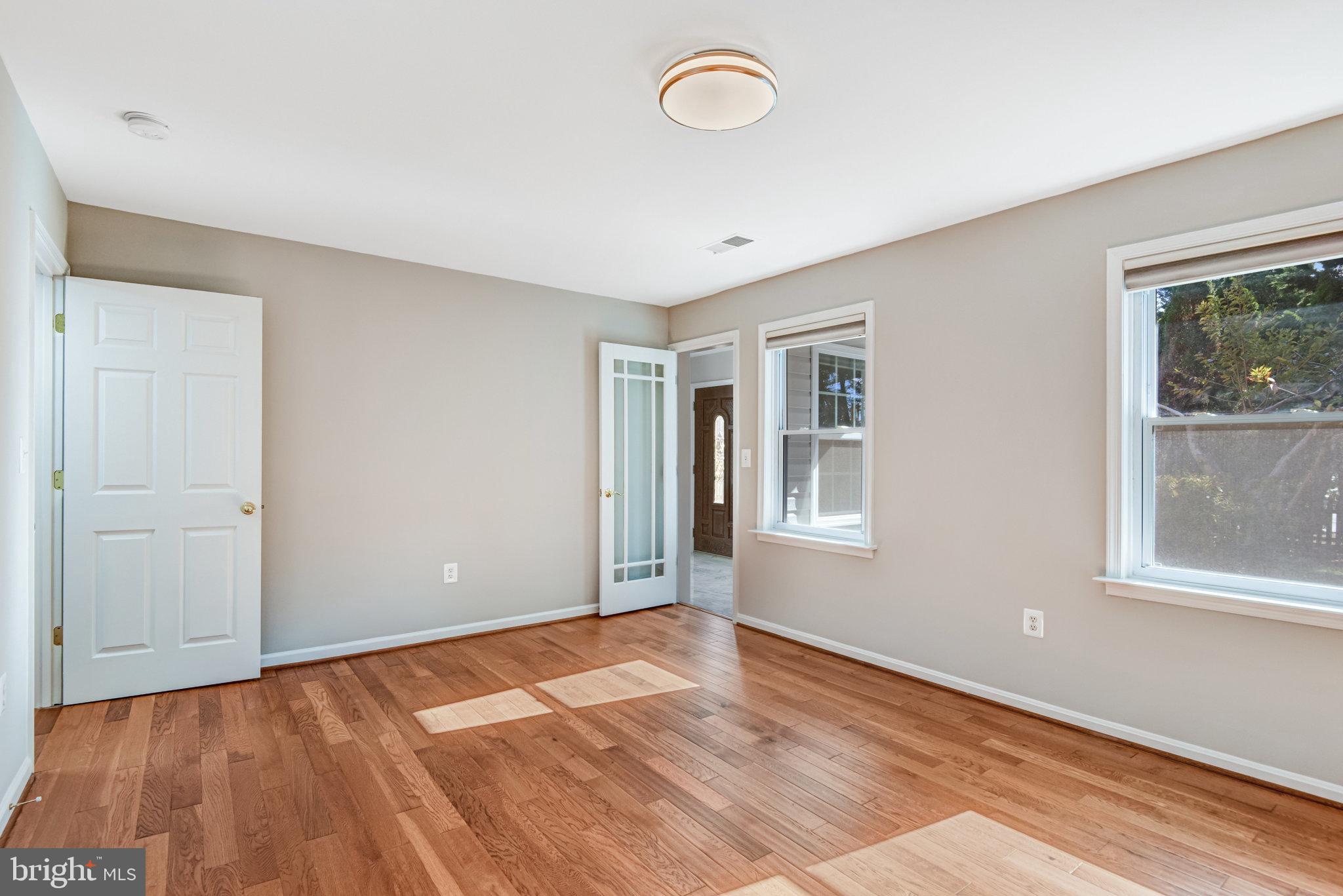 9720 Five Oaks Road Fairfax, VA 22031 - Photo 43 of 91 a view of an empty room with wooden floor and a window