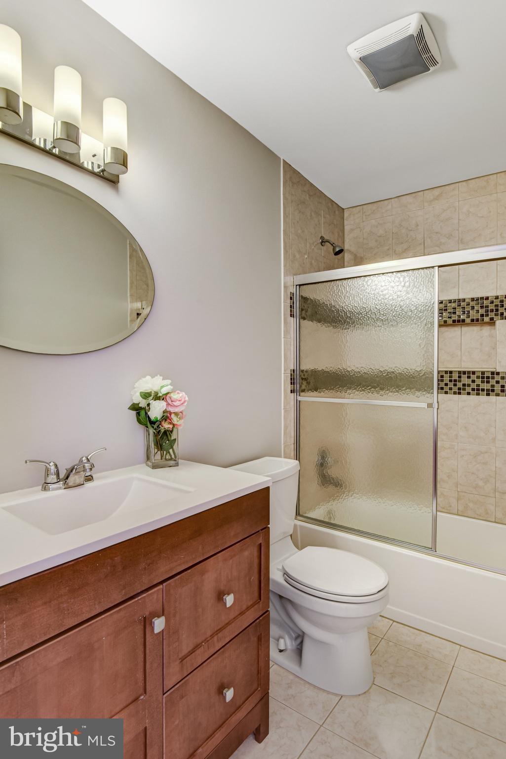 9720 Five Oaks Road Fairfax, VA 22031 - Photo 48 of 91 a bathroom with a granite countertop toilet sink and mirror
