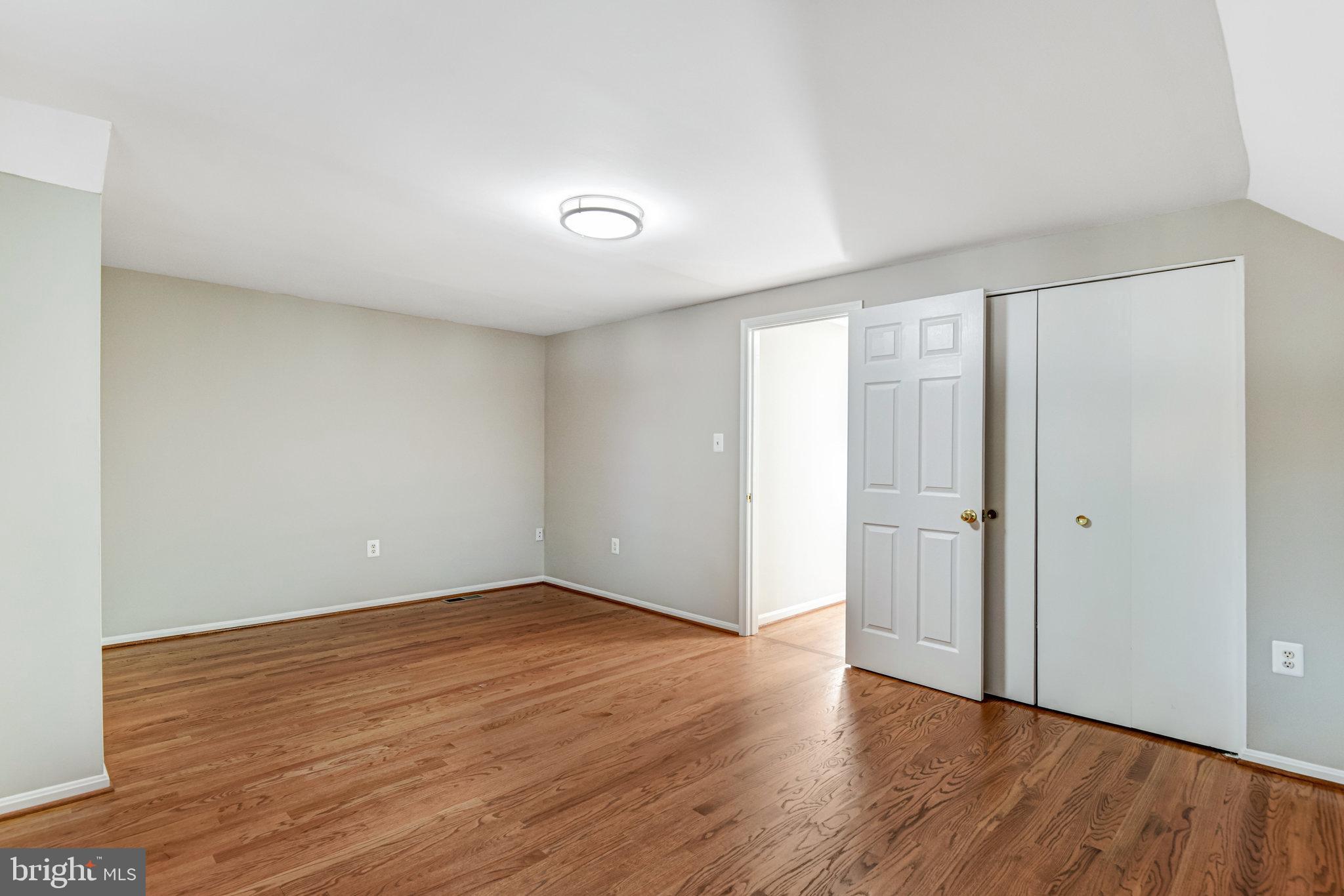 9720 Five Oaks Road Fairfax, VA 22031 - Photo 59 of 91 a view of an empty room with wooden floor and closet