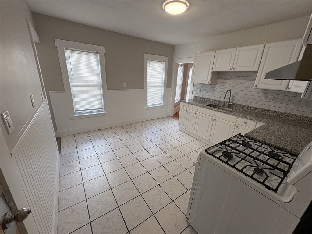 85 Swan Street, Unit 3 Everett, MA 02149 - Photo 2 of 9 a kitchen with a sink a stove and cabinets