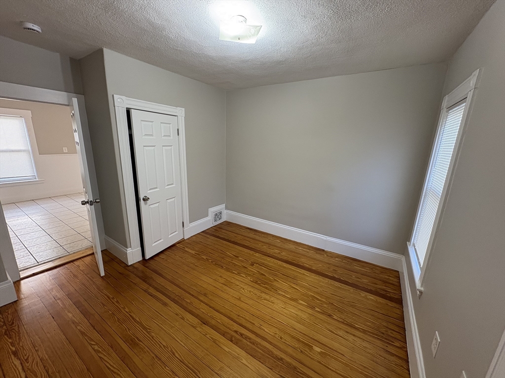 85 Swan Street, Unit 3 Everett, MA 02149 - Photo 4 of 9 wooden floor in an empty room