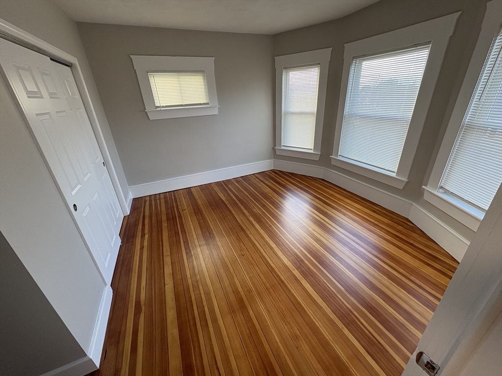 85 Swan Street, Unit 3 Everett, MA 02149 - Photo 7 of 9 a view of a room with wooden floor and staircase