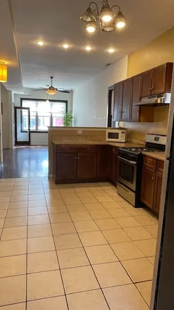 a kitchen with stainless steel appliances granite countertop a stove a sink and a microwave