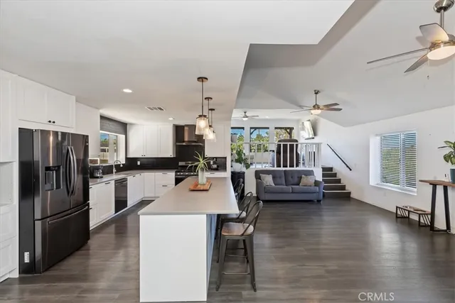 a kitchen with a table chairs and wooden floor