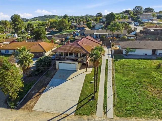 an aerial view of residential houses with outdoor space and street view
