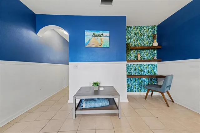 a living room with furniture and a floor to ceiling window