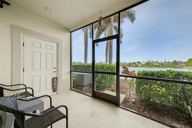 a balcony with a bench and a potted plant