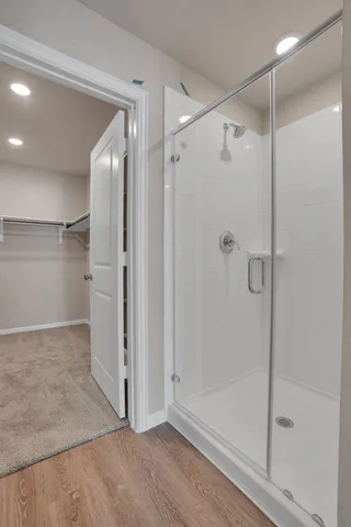 a bathroom with a glass shower door