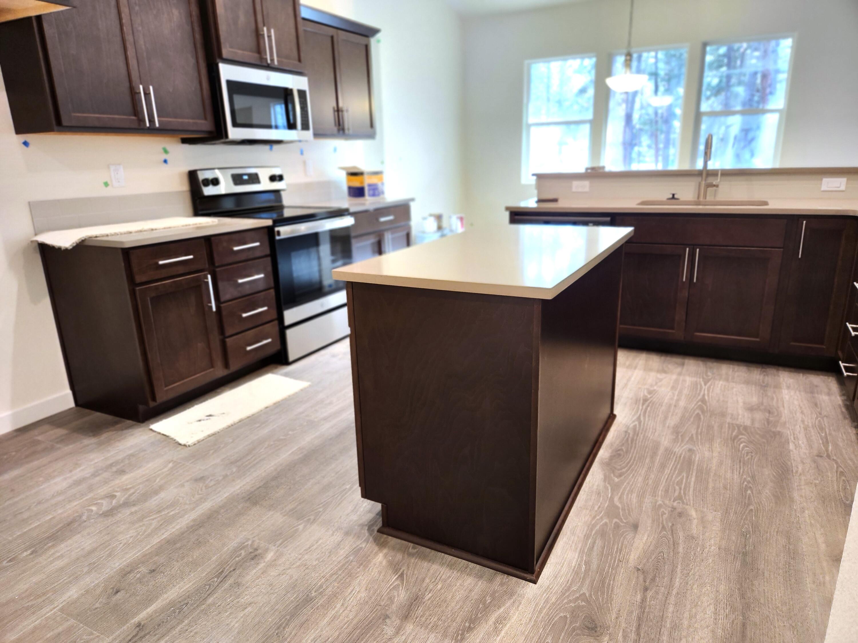 18867 Choctaw Road Bend, OR 97702 - Photo 2 of 22 Kitchen features SS appliances, quartz countertops, soft close drawers and luxury vinyl plank flooring.