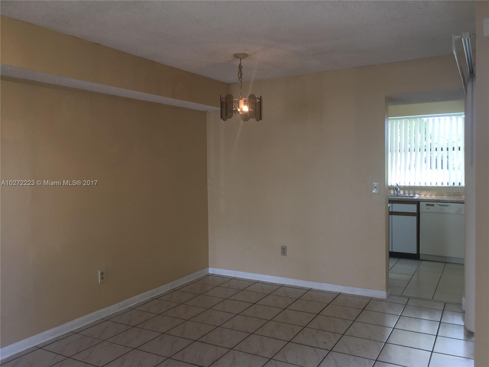 1071 Adams Avenue, Unit 1071F Homestead, FL 33034 - Photo 12 of 18 an empty room with windows and painted walls