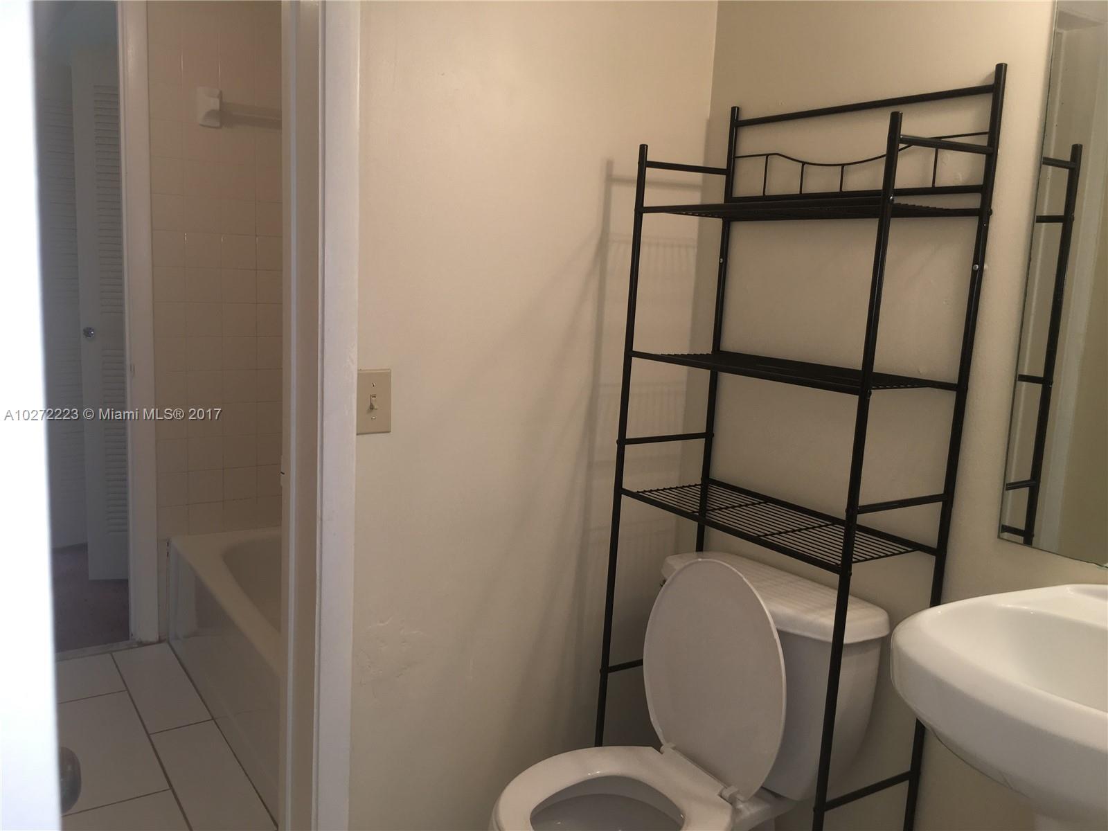 1071 Adams Avenue, Unit 1071F Homestead, FL 33034 - Photo 14 of 18 a bathroom with a toilet shower and sink