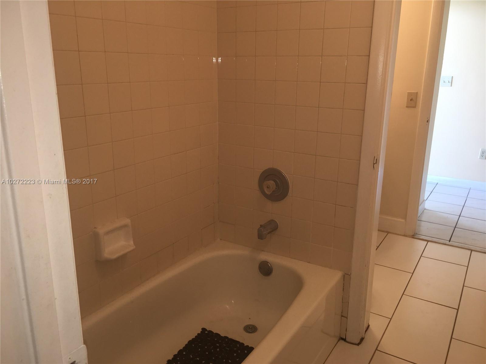 1071 Adams Avenue, Unit 1071F Homestead, FL 33034 - Photo 17 of 18 a bathroom with a bathtub