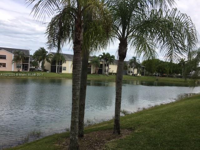 1071 Adams Avenue, Unit 1071F Homestead, FL 33034 - Photo 2 of 18 a view of a lake view with a garden