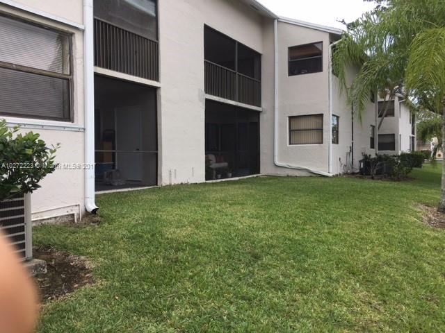 1071 Adams Avenue, Unit 1071F Homestead, FL 33034 - Photo 3 of 18 a view of an house with backyard space and a tree