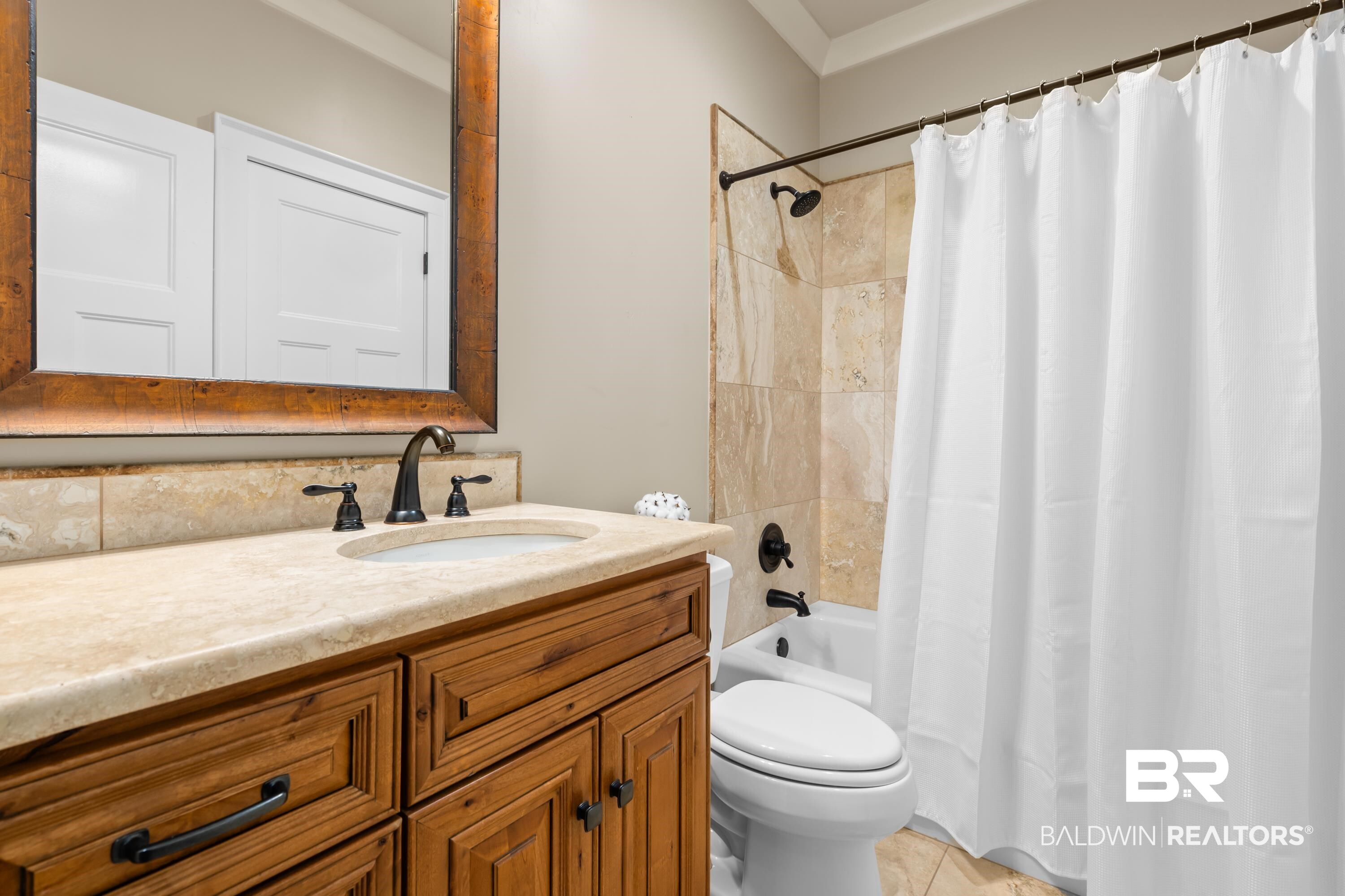 30057 Dolive Ridge Daphne, AL 36527 - Photo 29 of 55 Full bathroom with shower / bath combination with curtain, tile patterned floors, vanity, and toilet