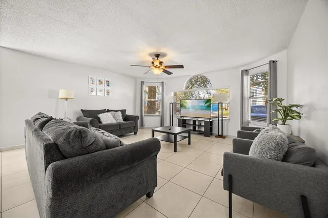 a living room with furniture and a chandelier