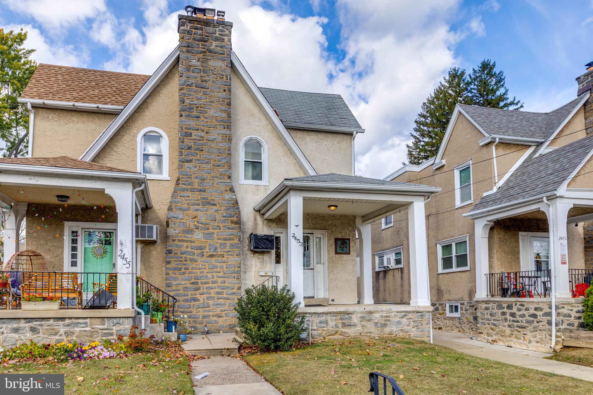 front view of a brick house with a small yard