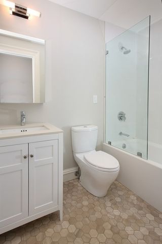 a white toilet sitting next to a bathroom sink