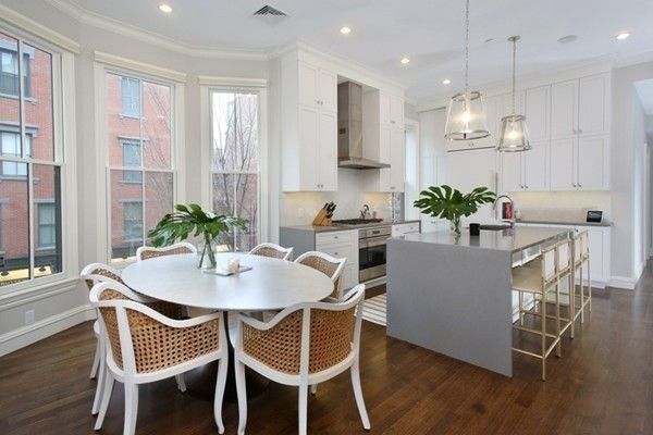 a dining room with furniture a chandelier and wooden floor