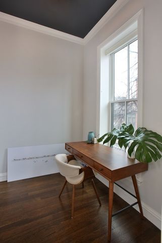 a view of a workspace with furniture and window